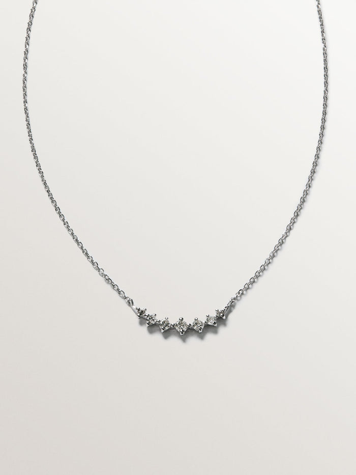 Colgante siente diamantes 0,15 ct  oro blanco