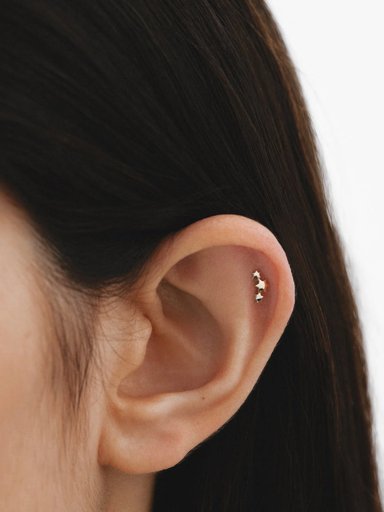 Piercing de oro amarillo de 18K con triple estrella