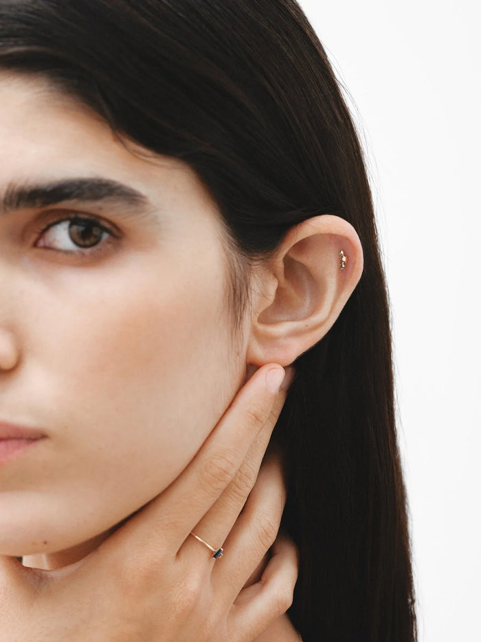 Piercing de oro amarillo de 18K con triple estrella