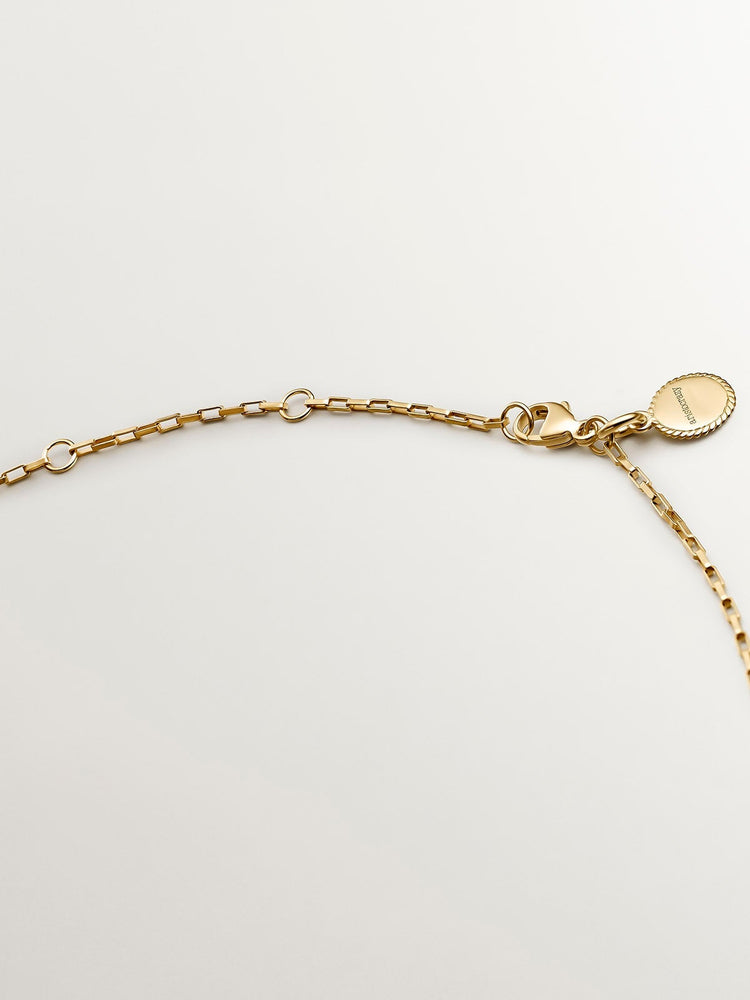 Colgante círculo de plata bañada en oro de 18kt con zafiros multicolor y tsavoritas verdes