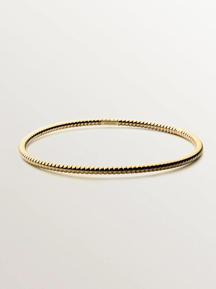 Pulsera rígida estilo semanario de plata 925 bañada en oro amarillo de 18K.