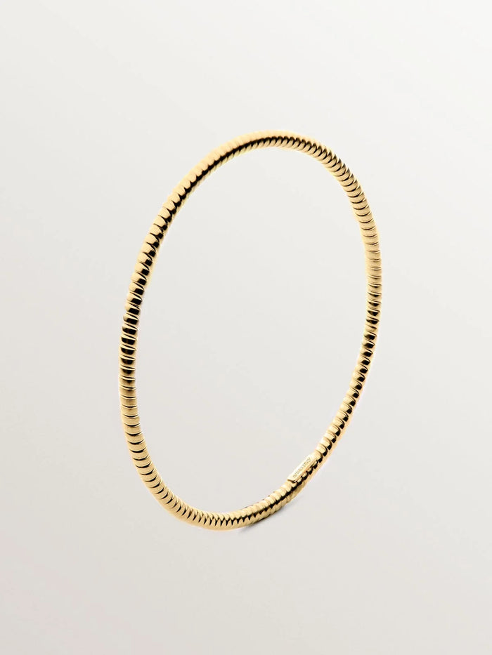 Pulsera rígida estilo semanario de plata 925 bañada en oro amarillo de 18K.